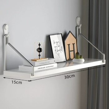 White shelf with decorative items against a gray wall