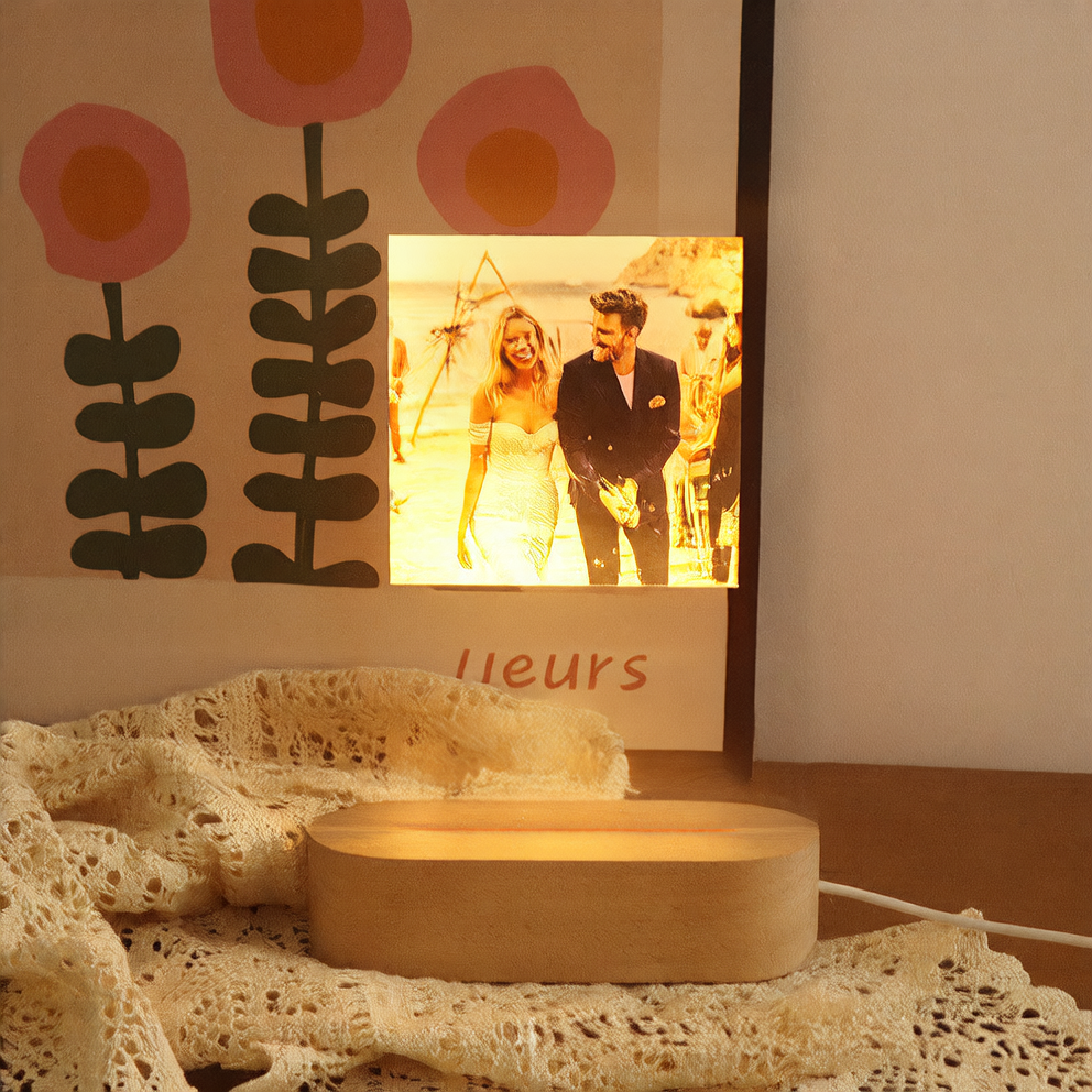 Framed photograph of a couple on a wall with decorative flowers above it.