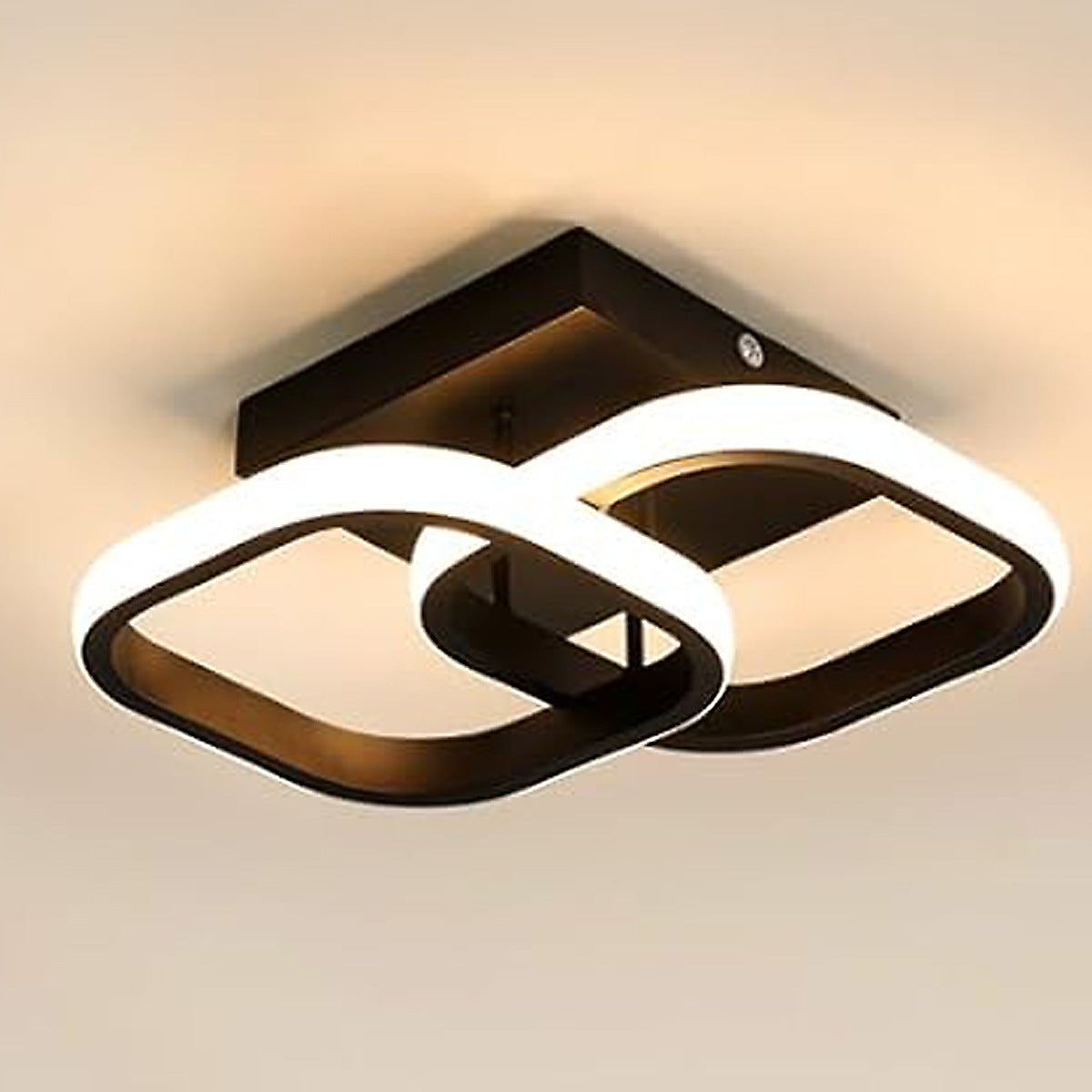 Modern ceiling light fixture with black and white design on a neutral background