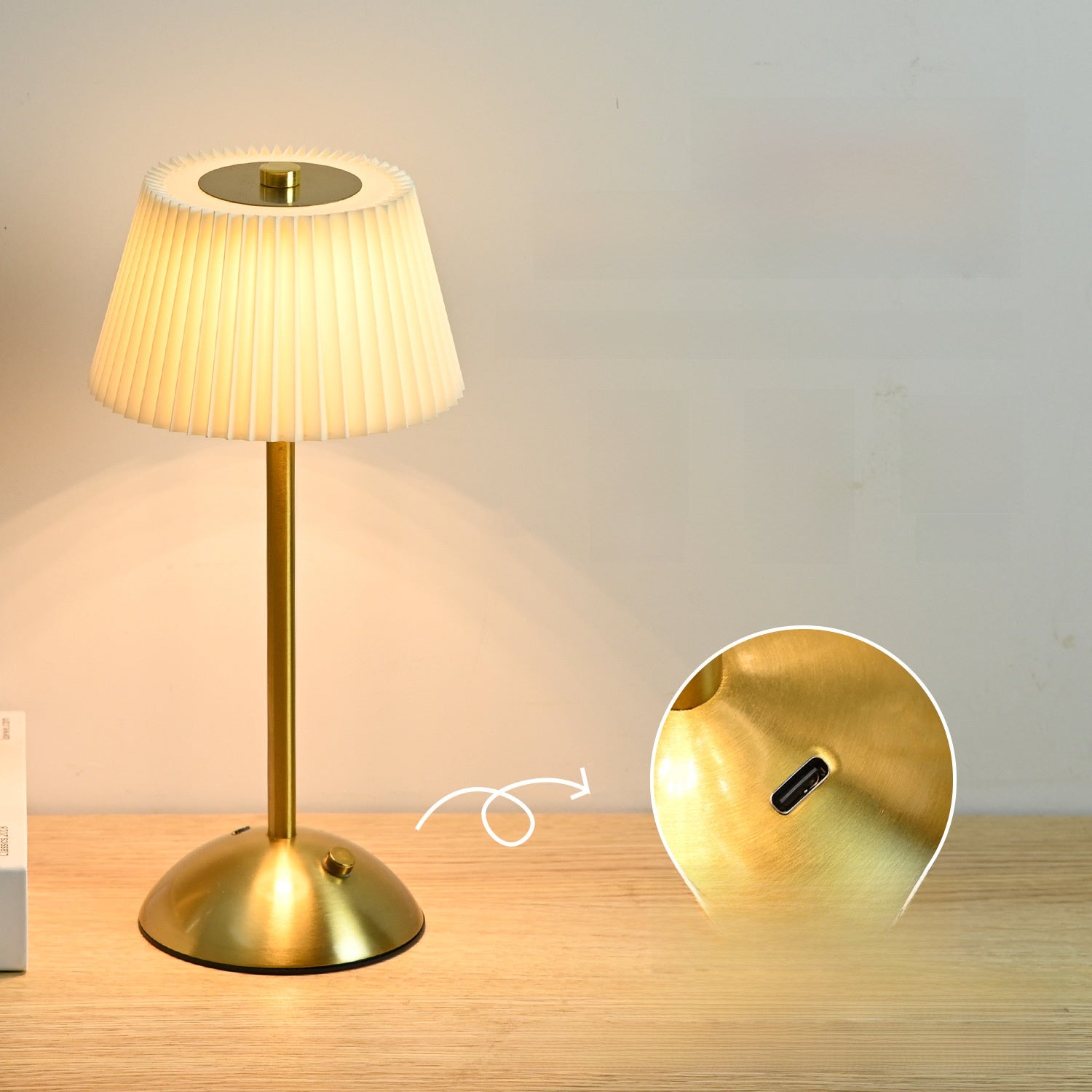 Gold table lamp with pleated shade on a wooden surface, inset showing USB port.