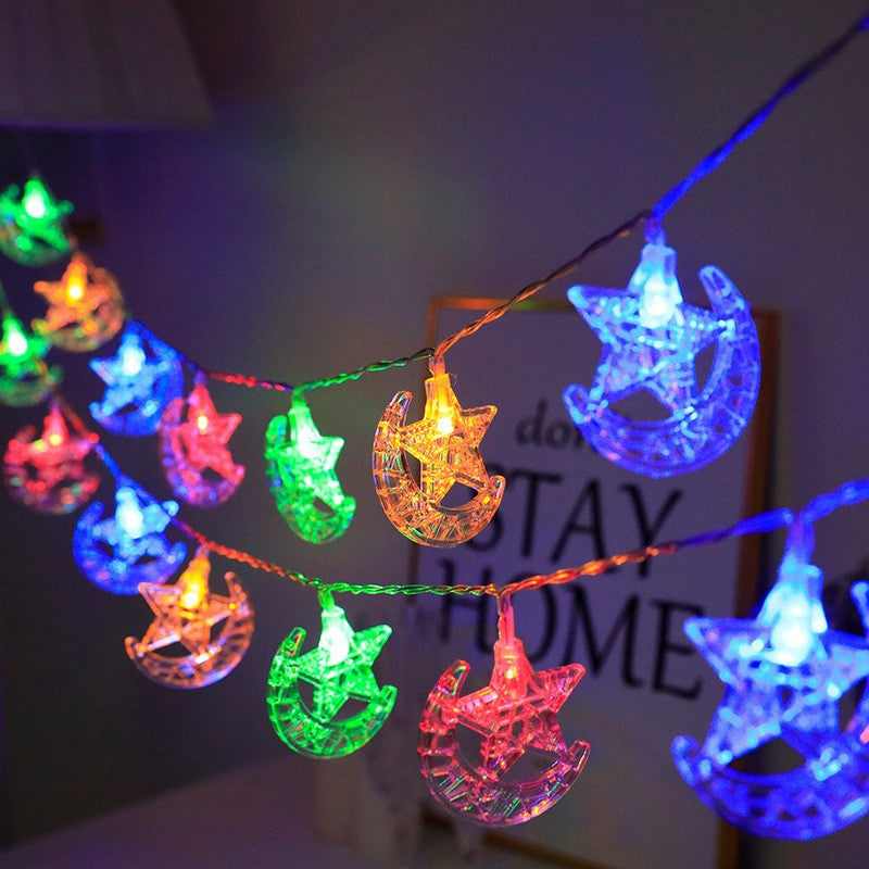 String lights with star and moon designs in multicolor on a dark background