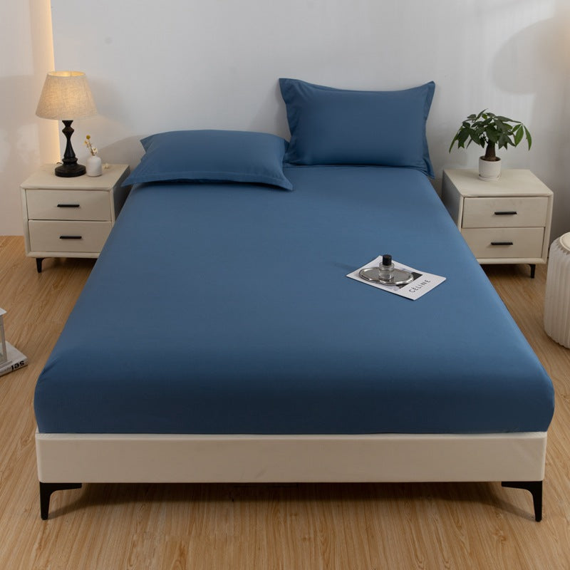 Blue bedspread on a bed in a bedroom with nightstands and decor.