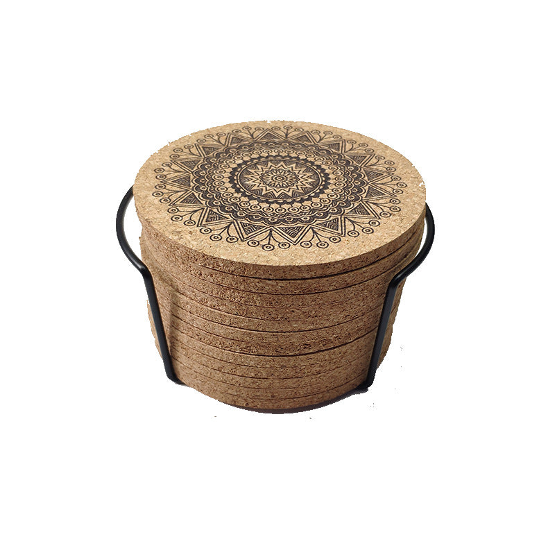 Set of cork coasters with mandala design in a round basket on a white background