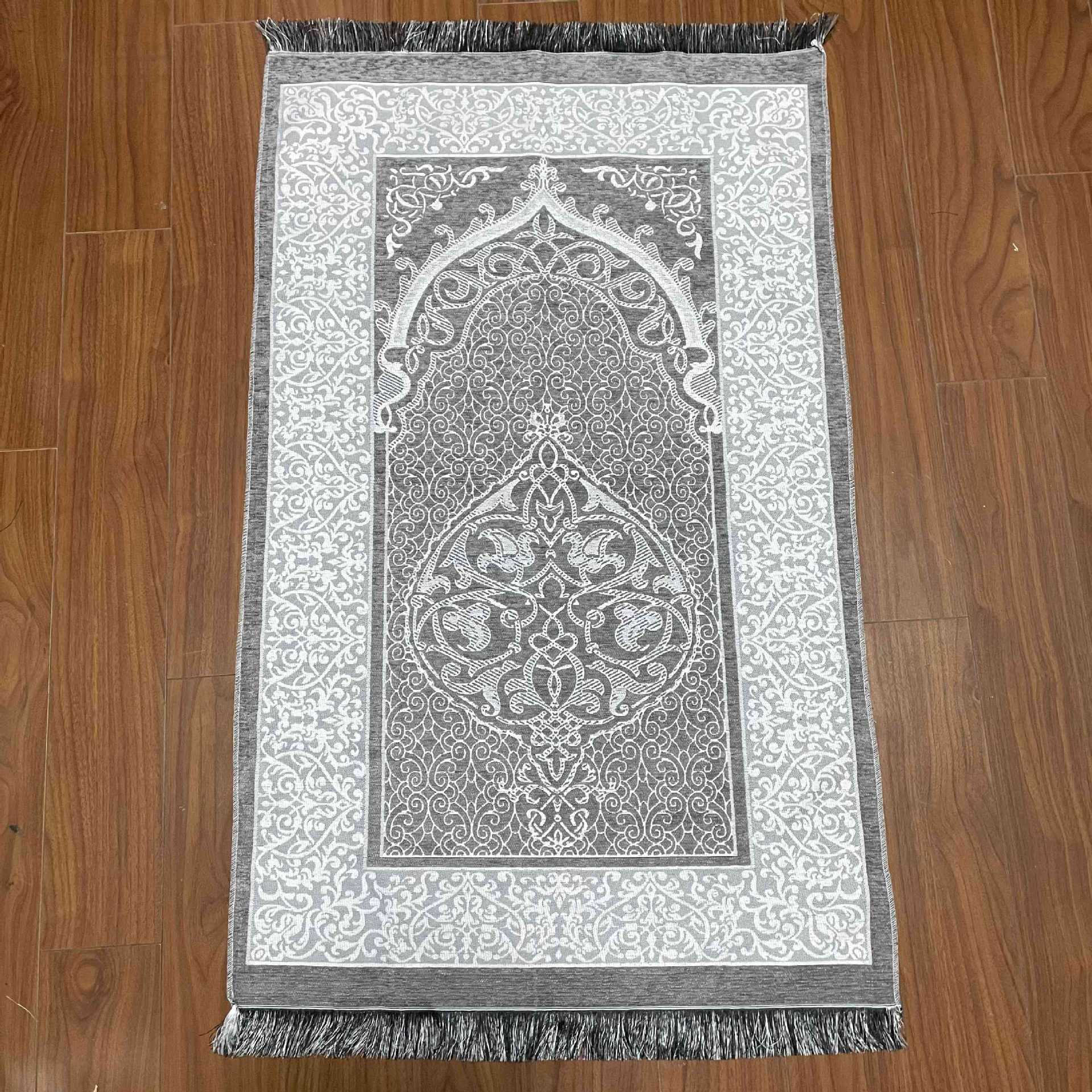 Decorative prayer mat with intricate patterns on a wooden floor