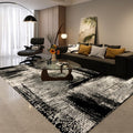 Modern living room with a black and white patterned rug, dark sofa, and decorative elements.