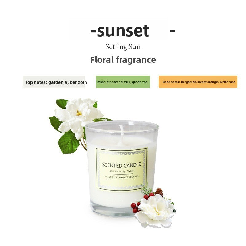 Scented candle labeled 'Sunset' with floral fragrance description on a white background