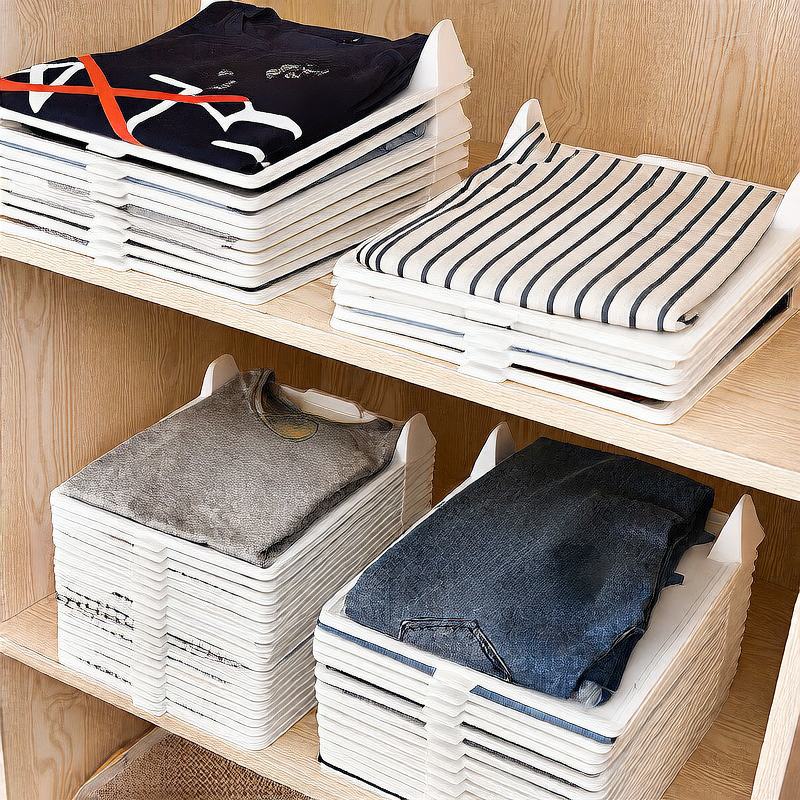 Stacks of folded clothes on wooden shelves