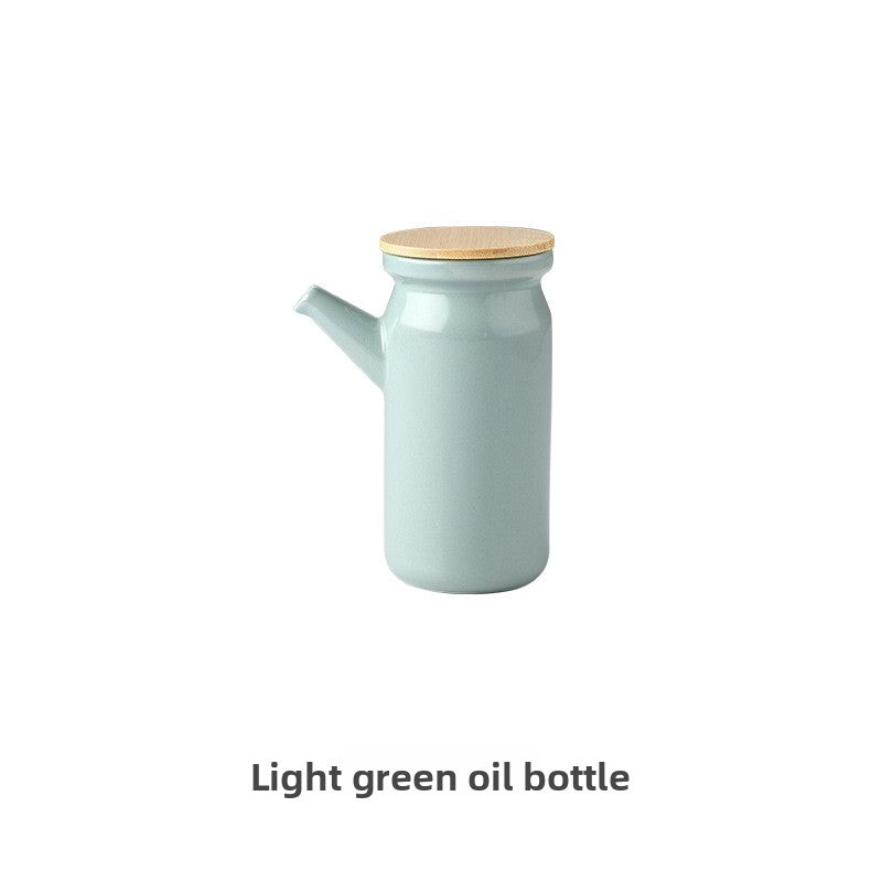 Light green oil bottle with a wooden lid on a white background