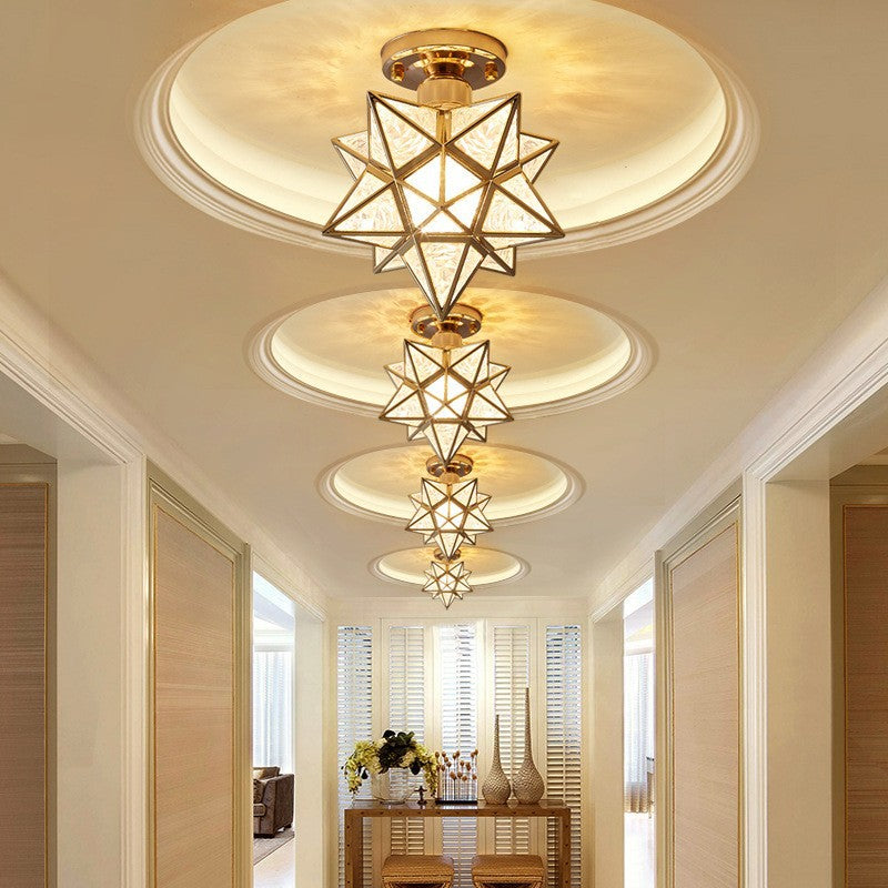 Modern chandelier hanging from a ceiling in a well-lit room with a table and chairs.