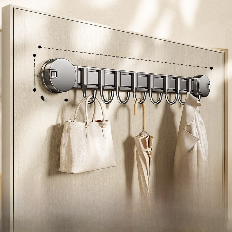 Wall-mounted hook rack with a handbag, shoes, and coat on a neutral background