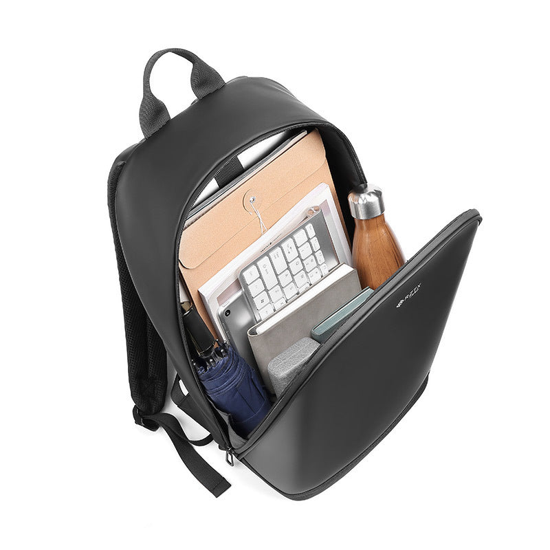 Black backpack with compartments containing a laptop, notebook, and other items on a white background