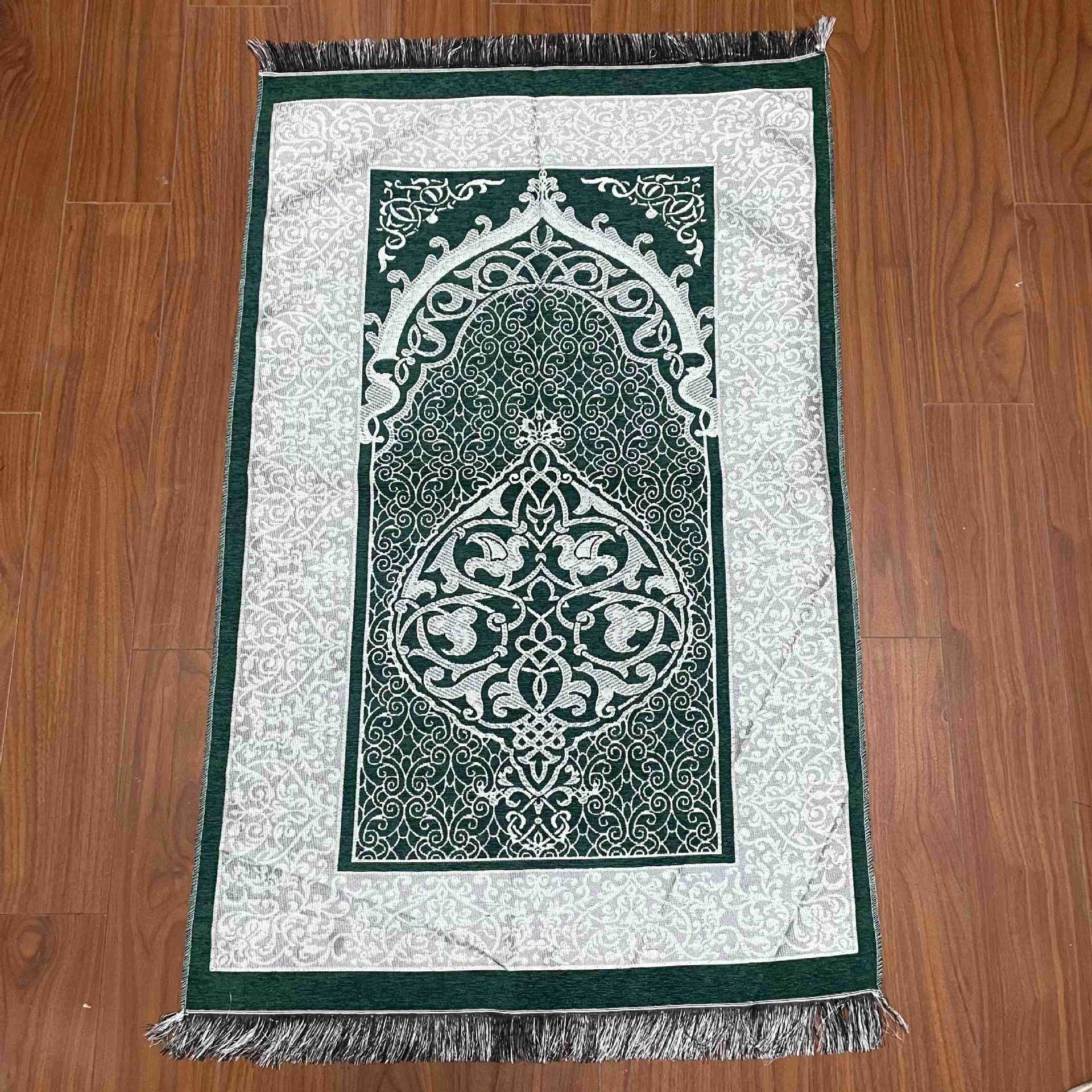 Decorative prayer mat with intricate design on a wooden floor