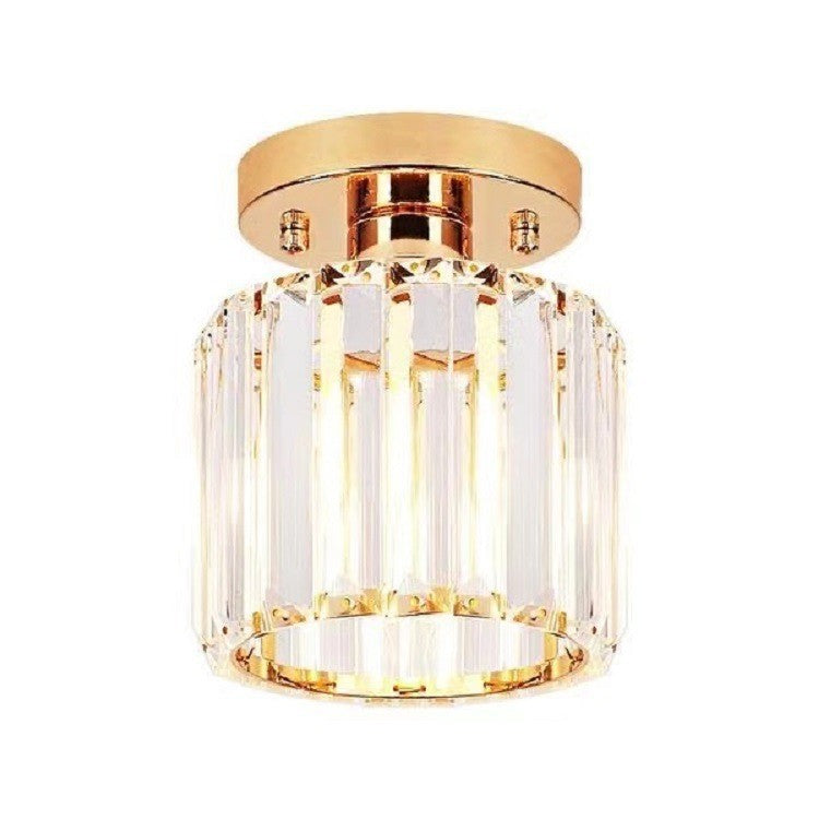 Gold ceiling light fixture with clear glass shade on a white background
