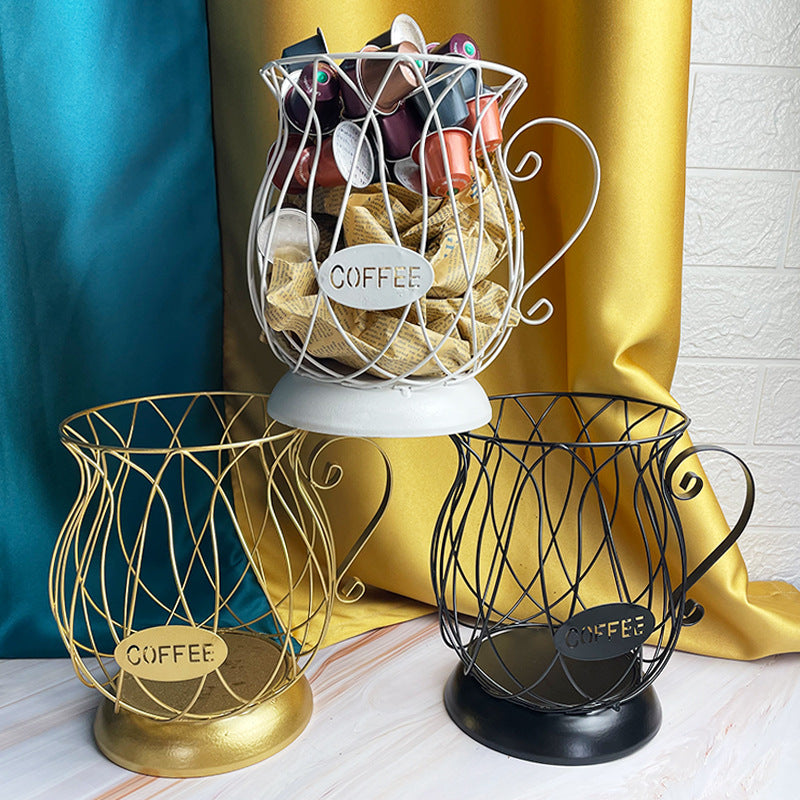 Decorative wire coffee capsules holder in gold, silver, and black with 'COFFEE' labels on a white surface.