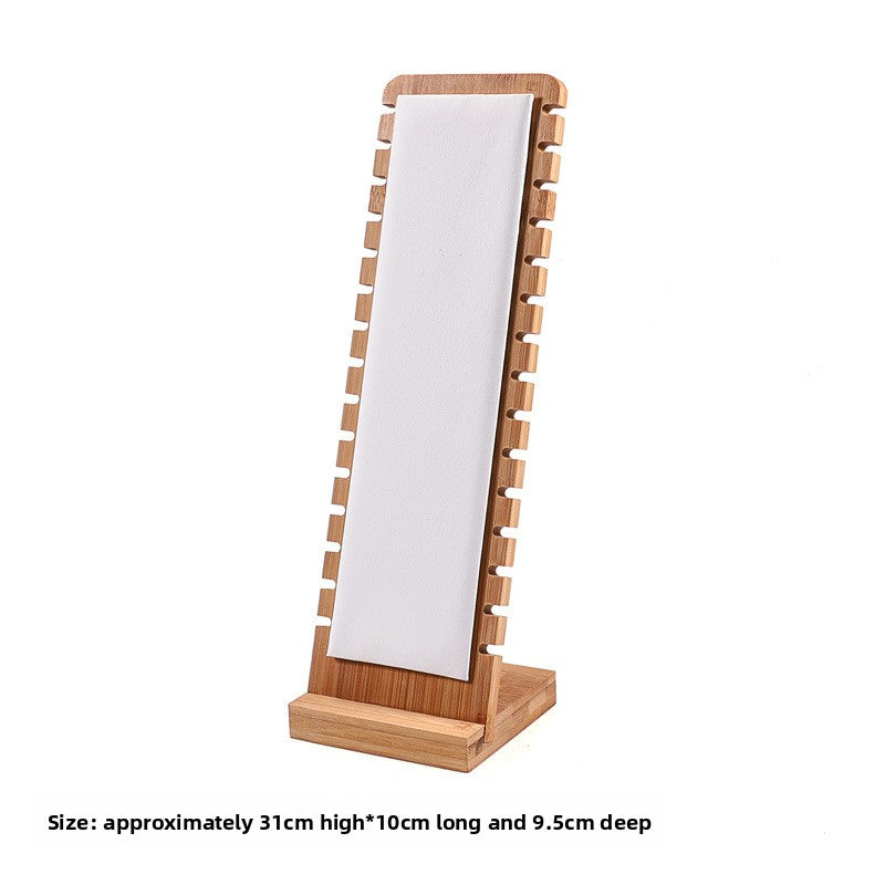 Wooden jewelry display stand with a white card on a white background