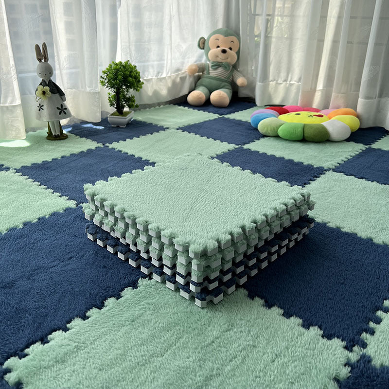 Children's playroom with foam puzzle mats in green and blue.