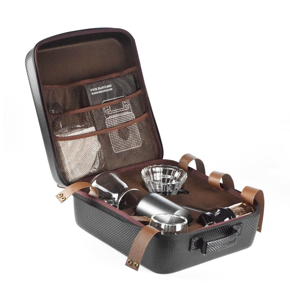 Open briefcase containing a set of silverware and glassware on a white background
