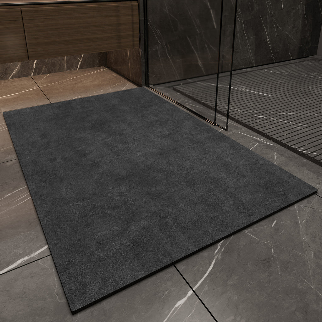 Dark gray mat on a tiled floor with a shower area in the background