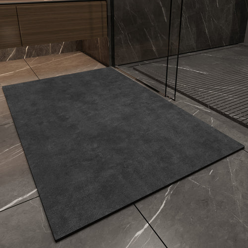 Dark gray mat on a tiled floor with a shower area in the background