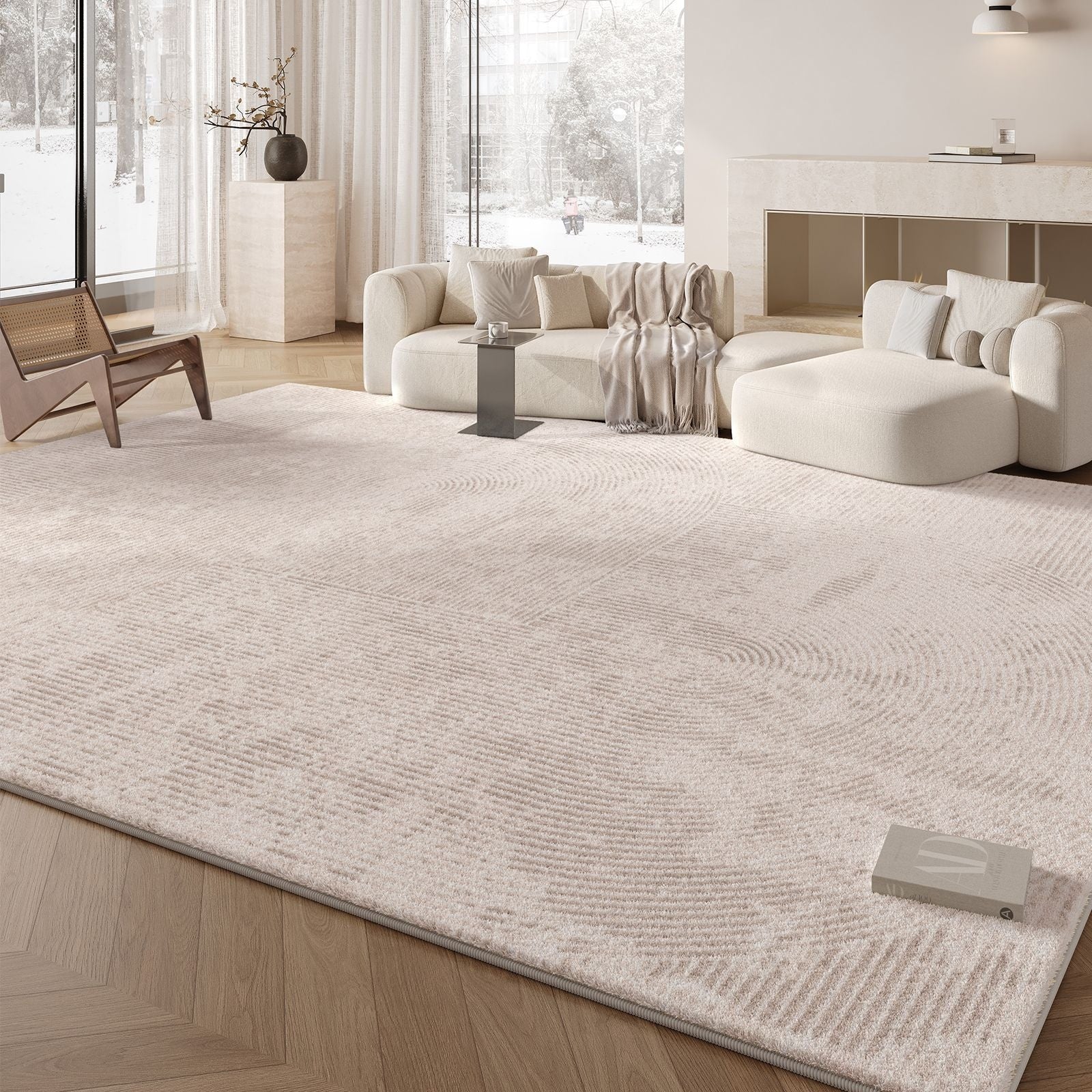 Modern living room with a large white rug, sofa, and decorative items.