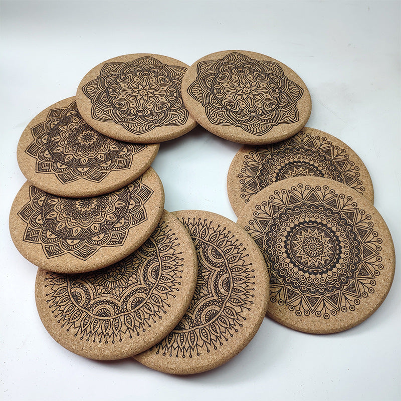 Set of cork coasters with mandala designs on a white background