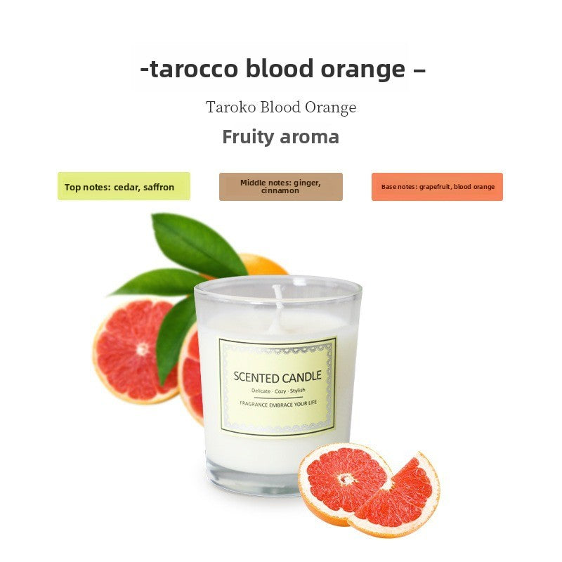 Scented candle with grapefruit slices and leaves on a white background