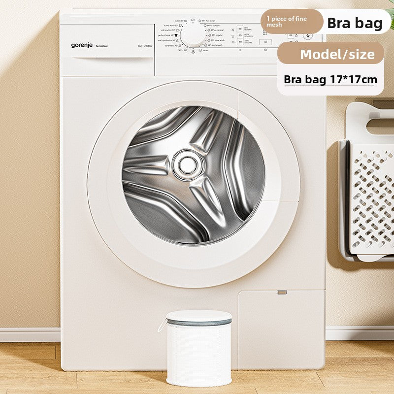 Washing machine with a bra bag labeled '17x17cm' in front of it.