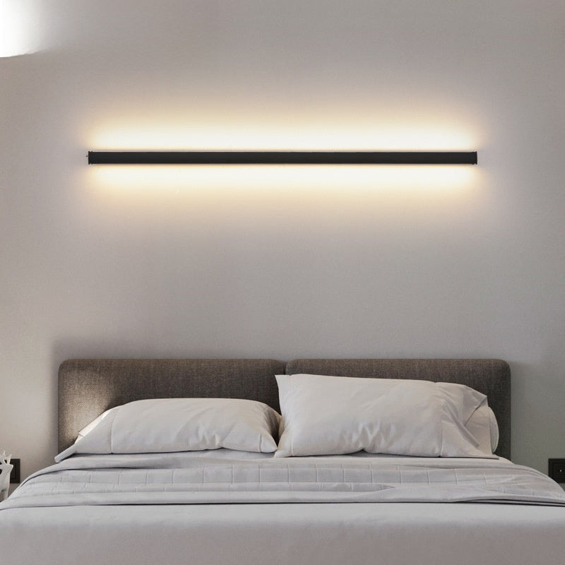 Bedroom with a modern wall light fixture above a bed