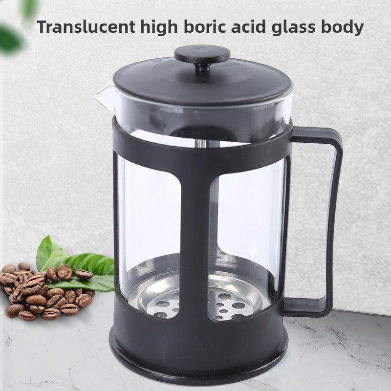 Black French press coffee maker with glass body on a light background