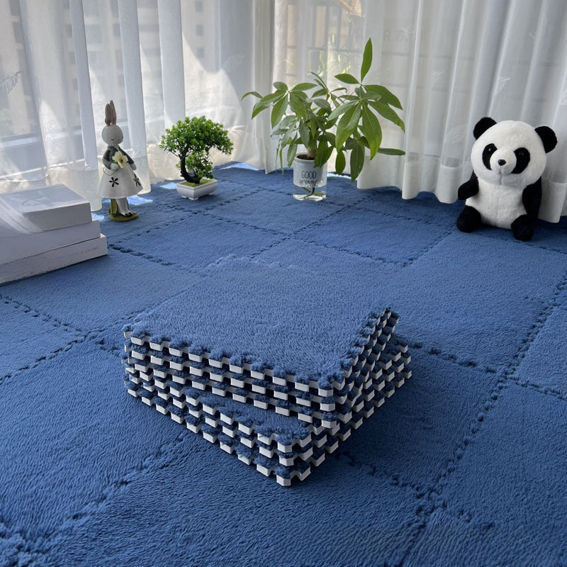 Blue interlocking foam mats in a room with white curtains and decorative items.