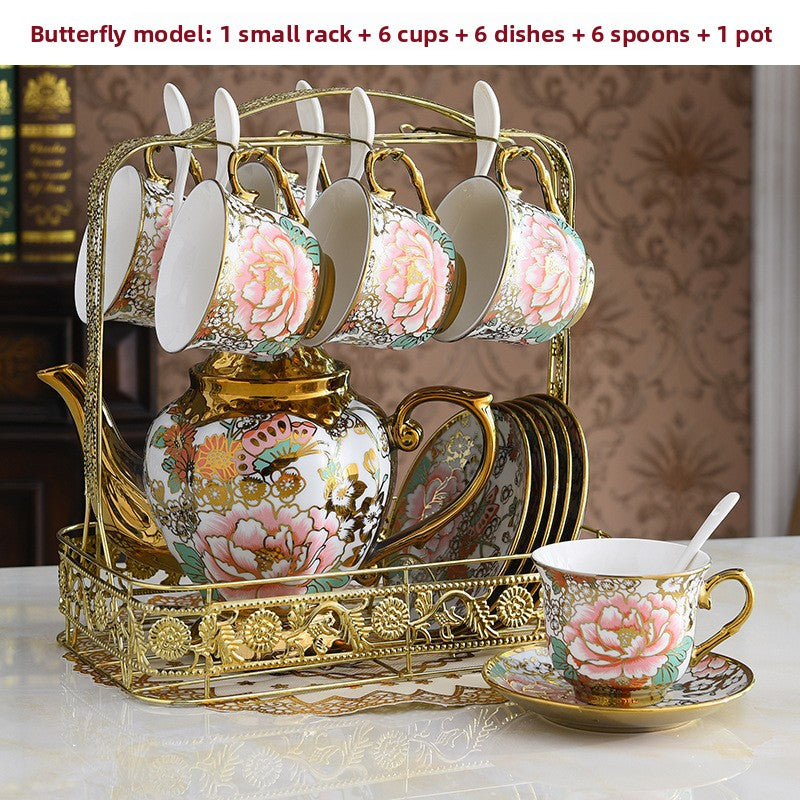 Decorative tea set with floral design on a gold stand