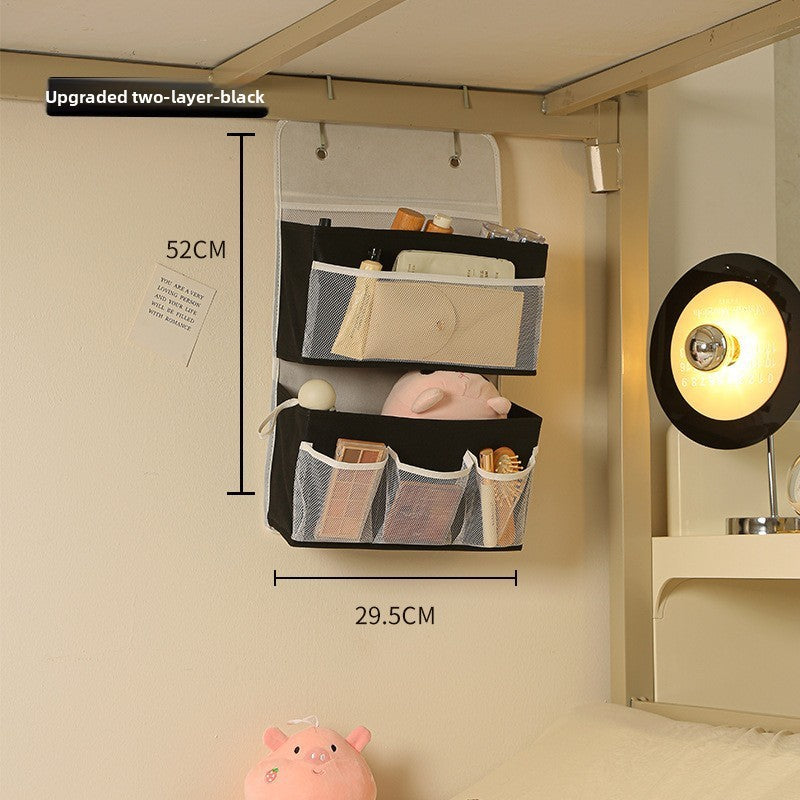 Wall-mounted storage bag with compartments on a beige wall, showing dimensions.