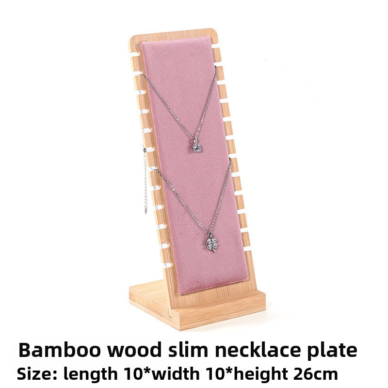 Bamboo wood slim necklace plate with a pink fabric backing displaying a necklace.