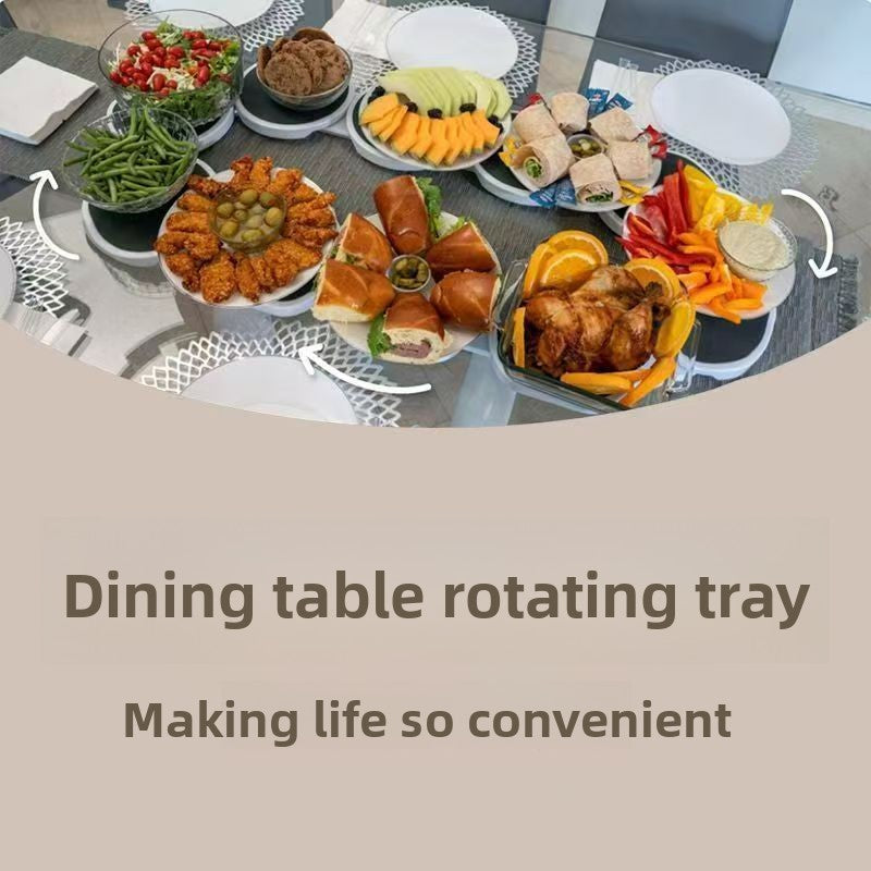 Dining table with a rotating tray displaying various food items on a neutral background.